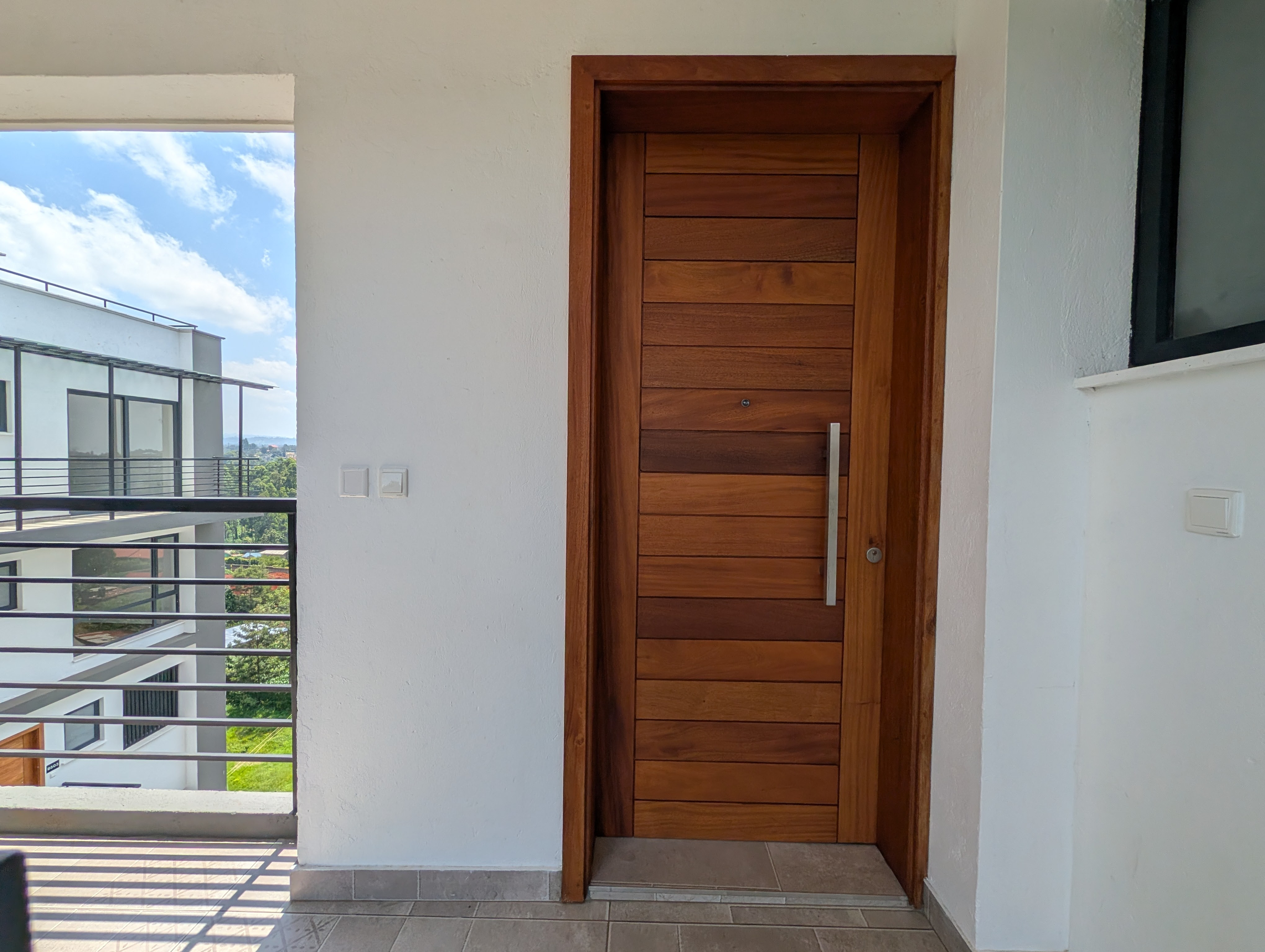 Solid hardwood front door with steel handle