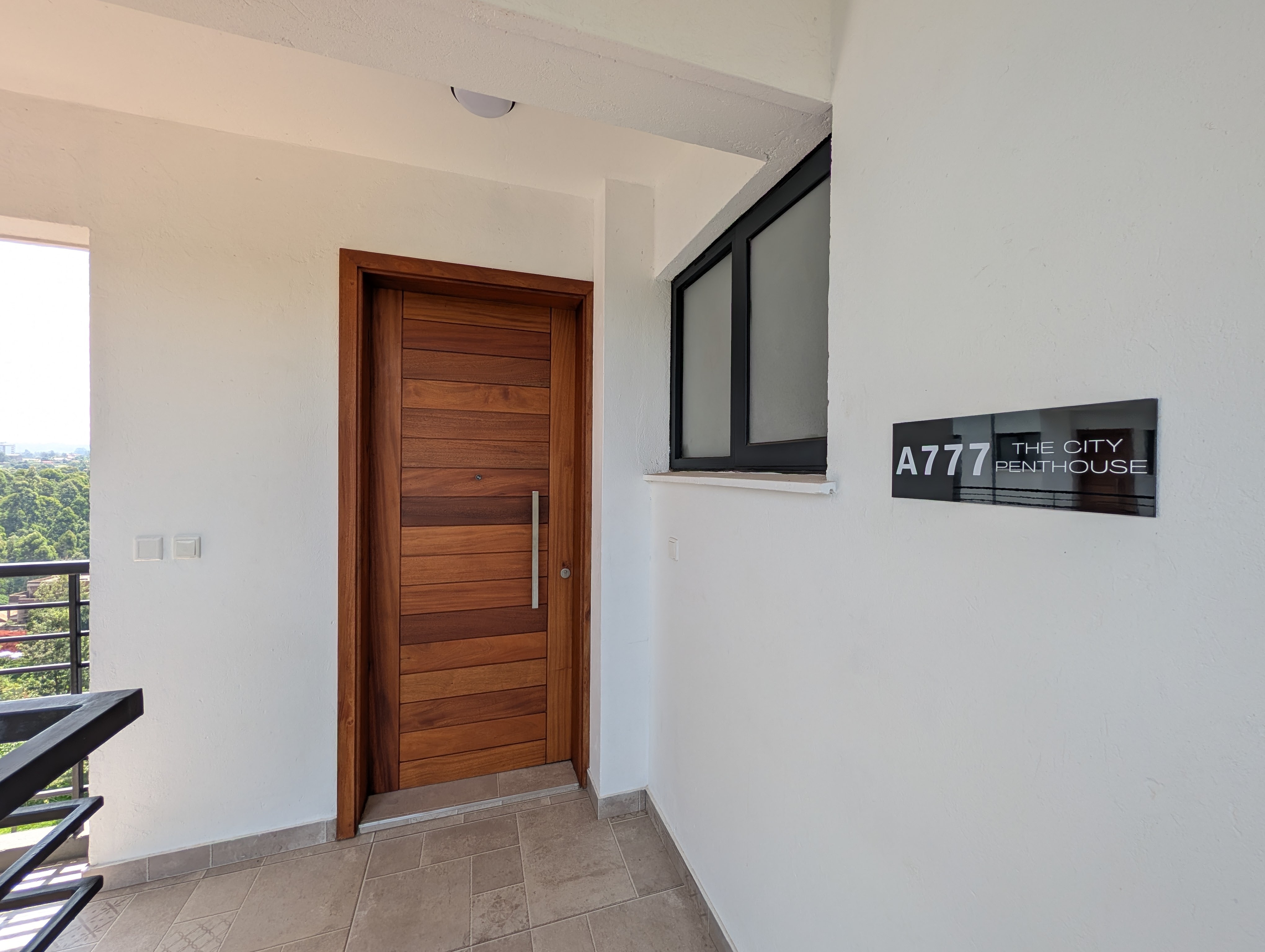 Unit A777 The City Penthouse nameplate and hardwood door